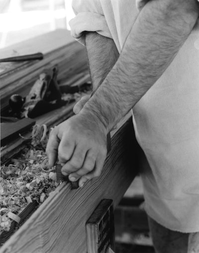 The historic way of crafting tongue-and-groove heart pine wood flooring, before machinery: At an event called Field Day of the Past in Goochland County, Va., I'm using a tongue cutter plane to create the tongue side of a heart pine board, starting at the front of the board and working my way back, constantly moving back and forth. (Arthur Jenkins)