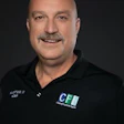 Smiling professional in black polo shirt with company logo