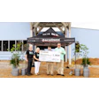 Schönox team donating $500 check at Earth Day 2025 community event.