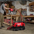Milwaukee power tools in woodworking workshop with miter saw and dust extraction system