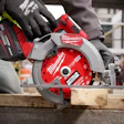 Milwaukee Fuel cordless circular saw cutting wood on construction site