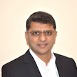 Professional businessman in black suit smiling with glasses