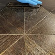 On this floor, you can see the plain background color around the perimeter and then the ceruse effect of gold mica dust in the next coat that remains in the open grain.