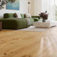 Modern living room with green sectional sofa, marble coffee table, and wooden floor