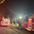 Fire trucks parked at night with emergency lights illuminated
