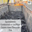 Burned dumpster interior with charred debris after spontaneous combustion of oily rags