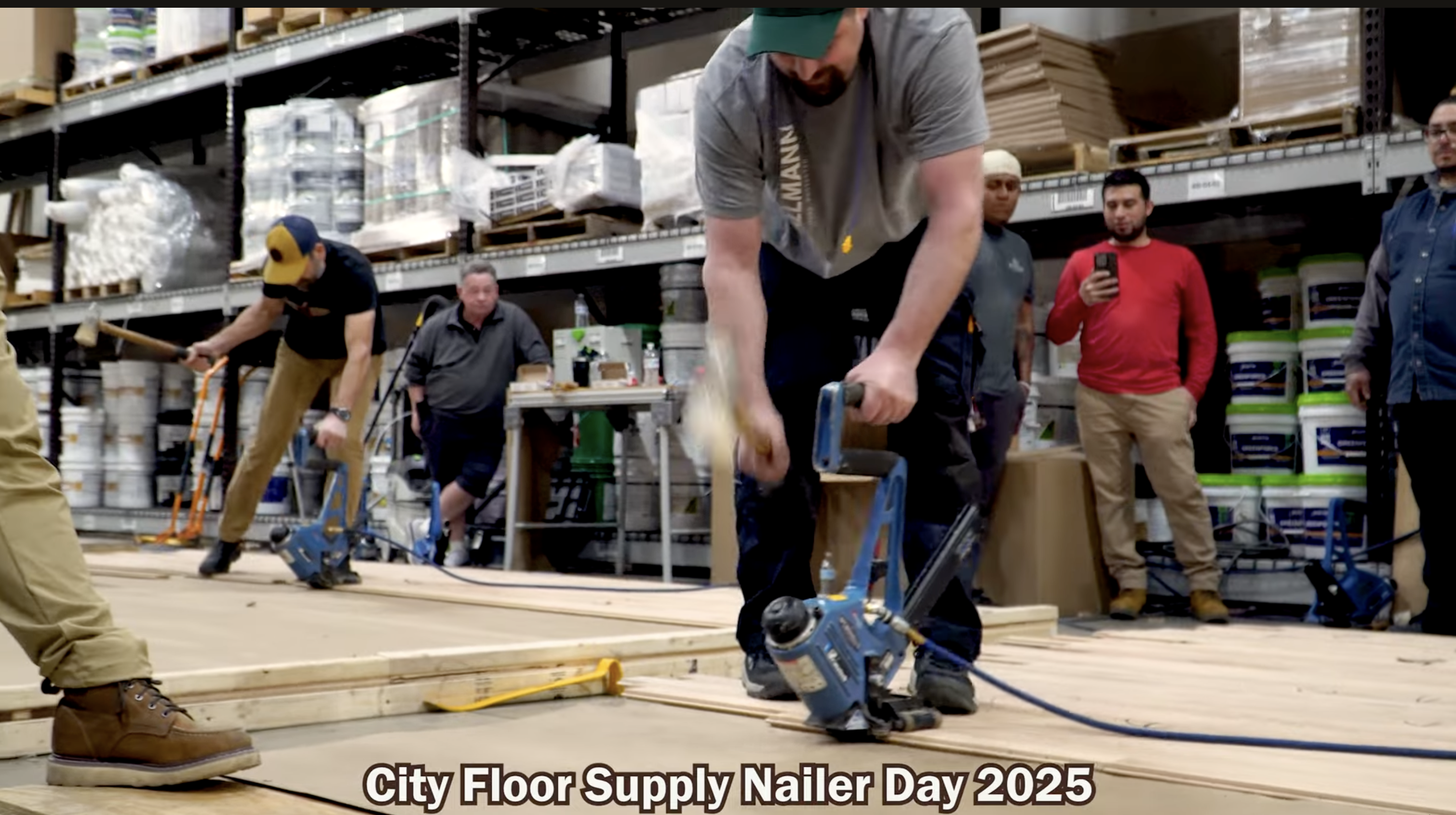 Workers using floor nailer equipment during City Floor Supply training event