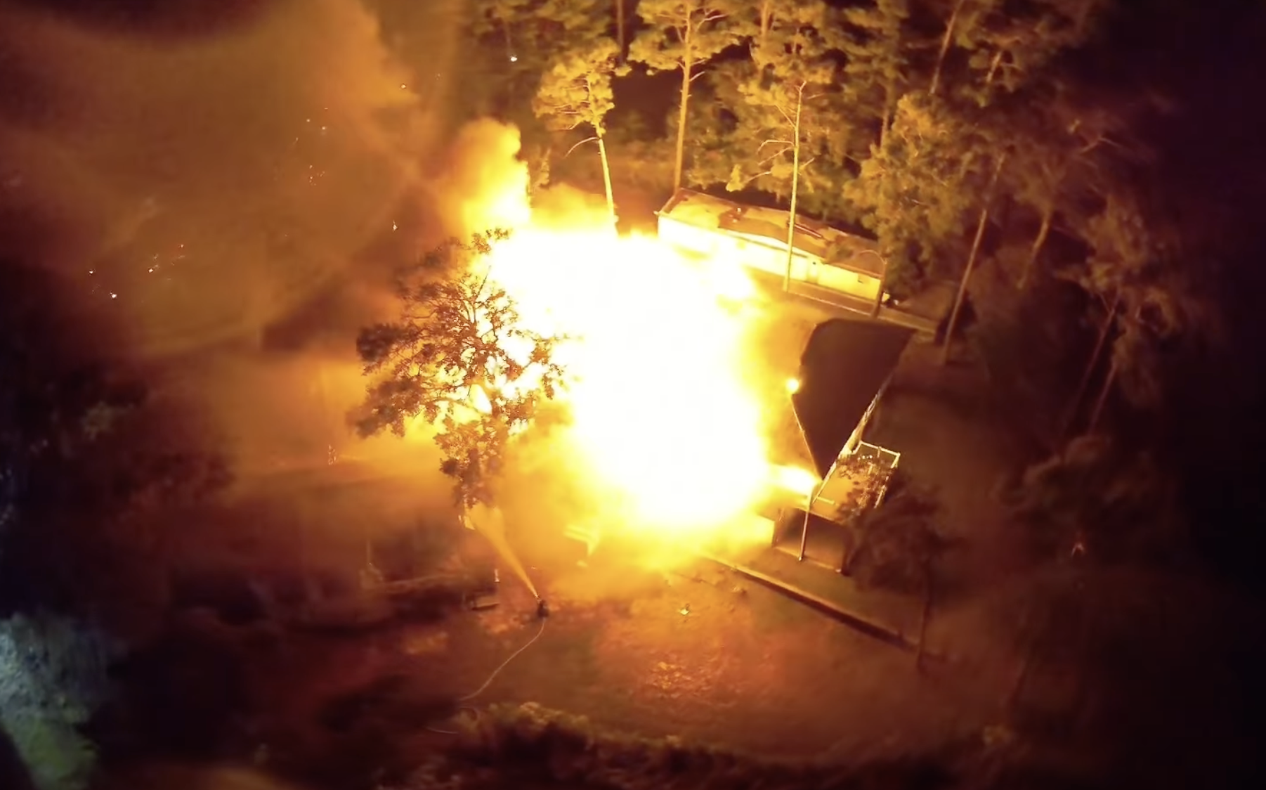 A still shot from a drone video from the Oak Island Fire Department shows the home completely engulfed in flames after oil-based stain rags spontaneously combusted.
