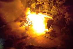 A still shot from a drone video from the Oak Island Fire Department shows the home completely engulfed in flames after oil-based stain rags spontaneously combusted.