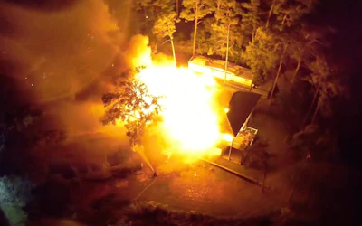 A still shot from a drone video from the Oak Island Fire Department shows the home completely engulfed in flames after oil-based stain rags spontaneously combusted.