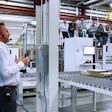 Manufacturing facility with worker operating machinery and production line