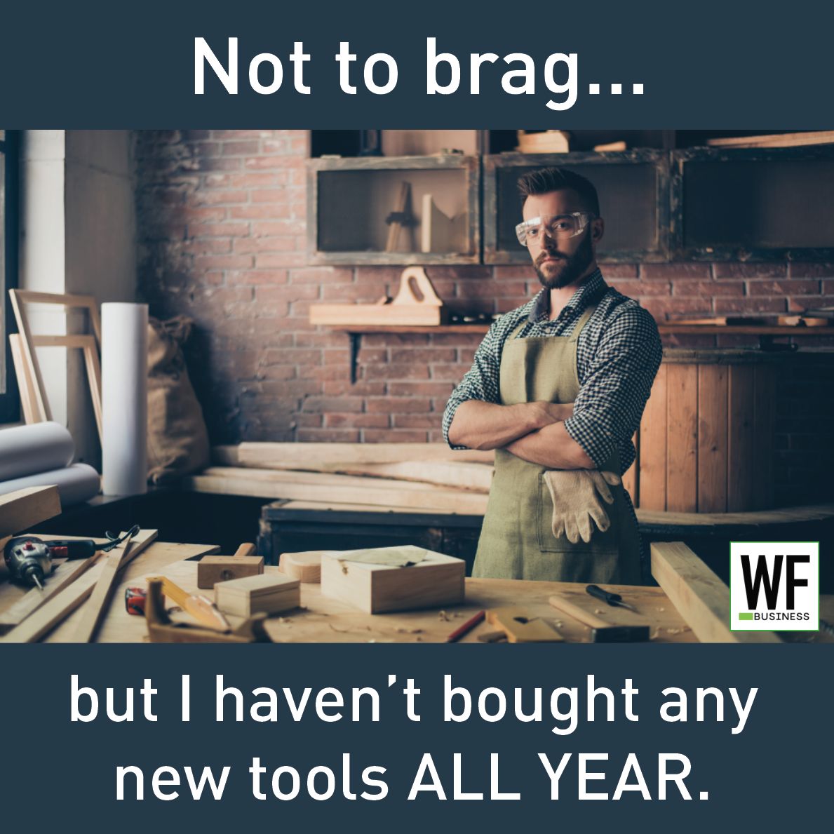 Woodworker in workshop wearing apron, surrounded by woodworking tools and materials