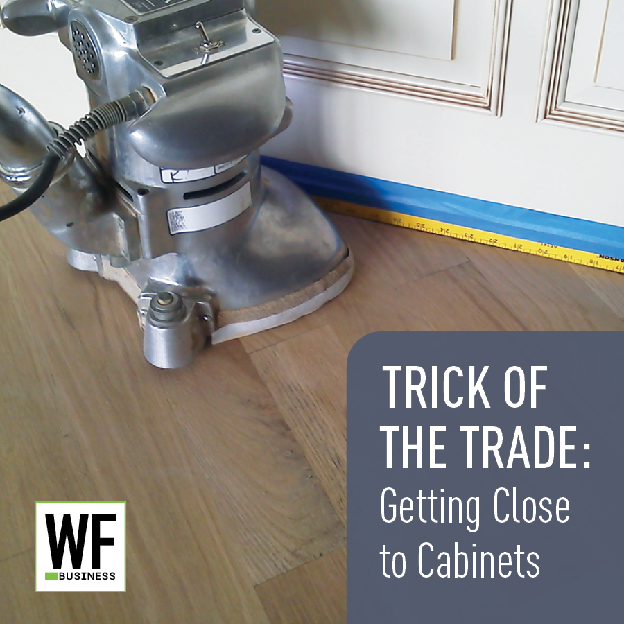 Floor sanding machine near cabinet with measuring tape and WF Business logo