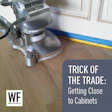 Floor sanding machine near cabinet with measuring tape and WF Business logo