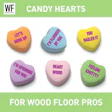 Candy hearts with wood flooring puns like 'Heart Wood' and 'Feeling Knotty?'