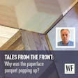 Parquet flooring detail with WF Business logo, investigating floor surface issue