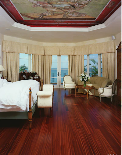 A sapele floor (with stain Duraseal oil-modified finish) by Endurance Floor Company. “The main challenge to working with sapele is the potential for indentation from steel edger wheels or dropping tools on the floor,” says Endurance’s Lenny Hall. “A very good dust containment protocol is also important, because the red dust from cutting and sanding tools gets airborne and will be carried everywhere.”