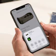 Smartphone displaying Houzz Pro app showing Annecy Sofa product listing priced at $3,298 with furniture details and options
