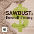 Sawdust with dollar sign symbol and WE Business logo promoting 'The smell of money' concept