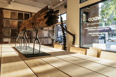 I had to have this sculpture of bronze human figures carrying a piece of reclaimed river wood on their shoulders. It's the perfect metaphor for our industry.