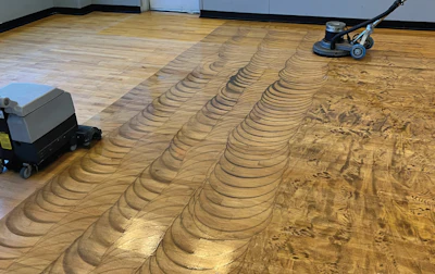 Once we started scrubbing it, you could see how incredibly dirty this gym floor was. This is just filth—no polishes.