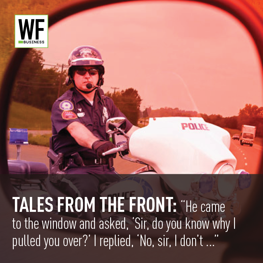 Police officer on motorcycle with WF Business logo overlay in warm-toned highway scene