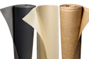 Three rolls of flooring underlayment or material in black, cream, and cork finishes displayed side by side
