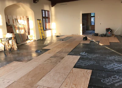 The single-layer plywood subfloor creates less of a height difference and saves money on adhesive.