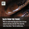 Polished brown leather dress shoes with decorative stitching displayed on wooden surface