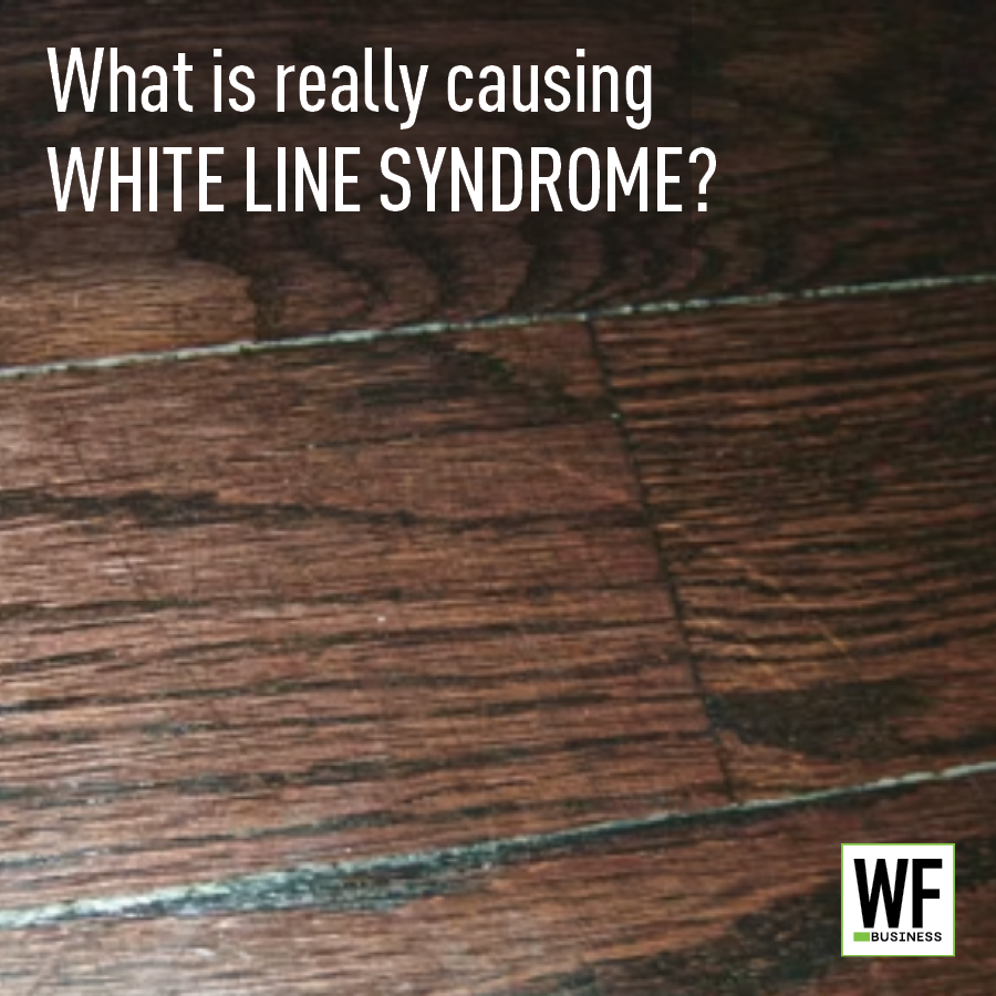 Hardwood floor with white lines between planks and WF Business logo