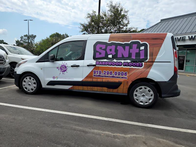 Santi Hardwood Floors' van sits outside the client's home, advertising Santi's services. Then, the neighbors receive a postcard in the mail.