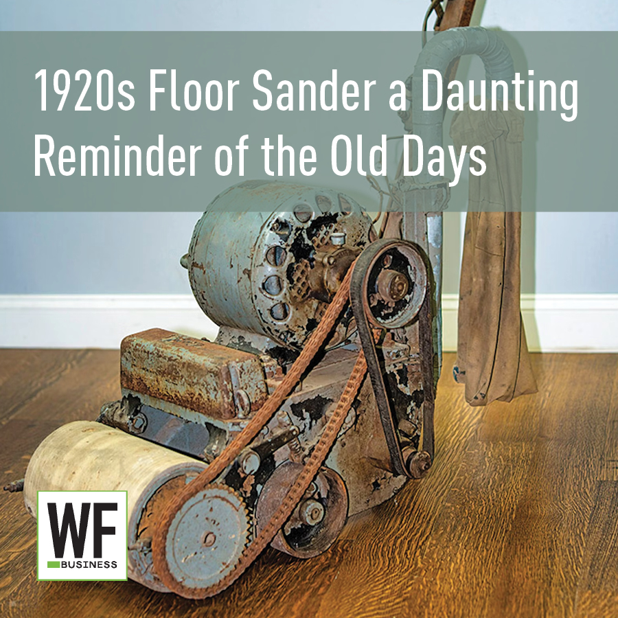 Vintage 1920s floor sander with rusted metal components on wooden floor