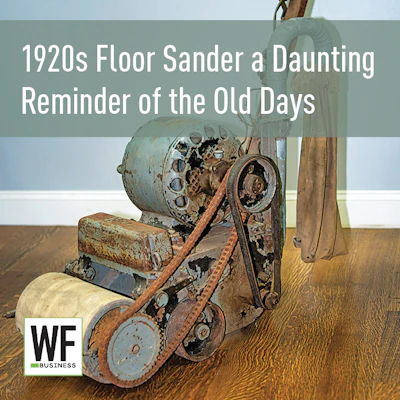 Vintage 1920s floor sander with rusted metal components on wooden floor