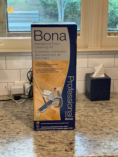 Bona Hardwood Floor Cleaning Kit box on kitchen granite countertop with windows in background