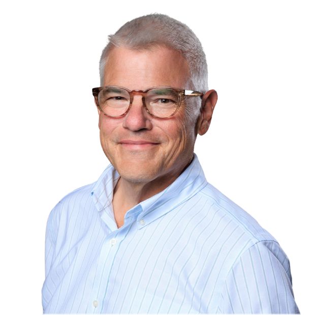 Professional headshot of middle-aged man wearing light blue pinstriped shirt and glasses