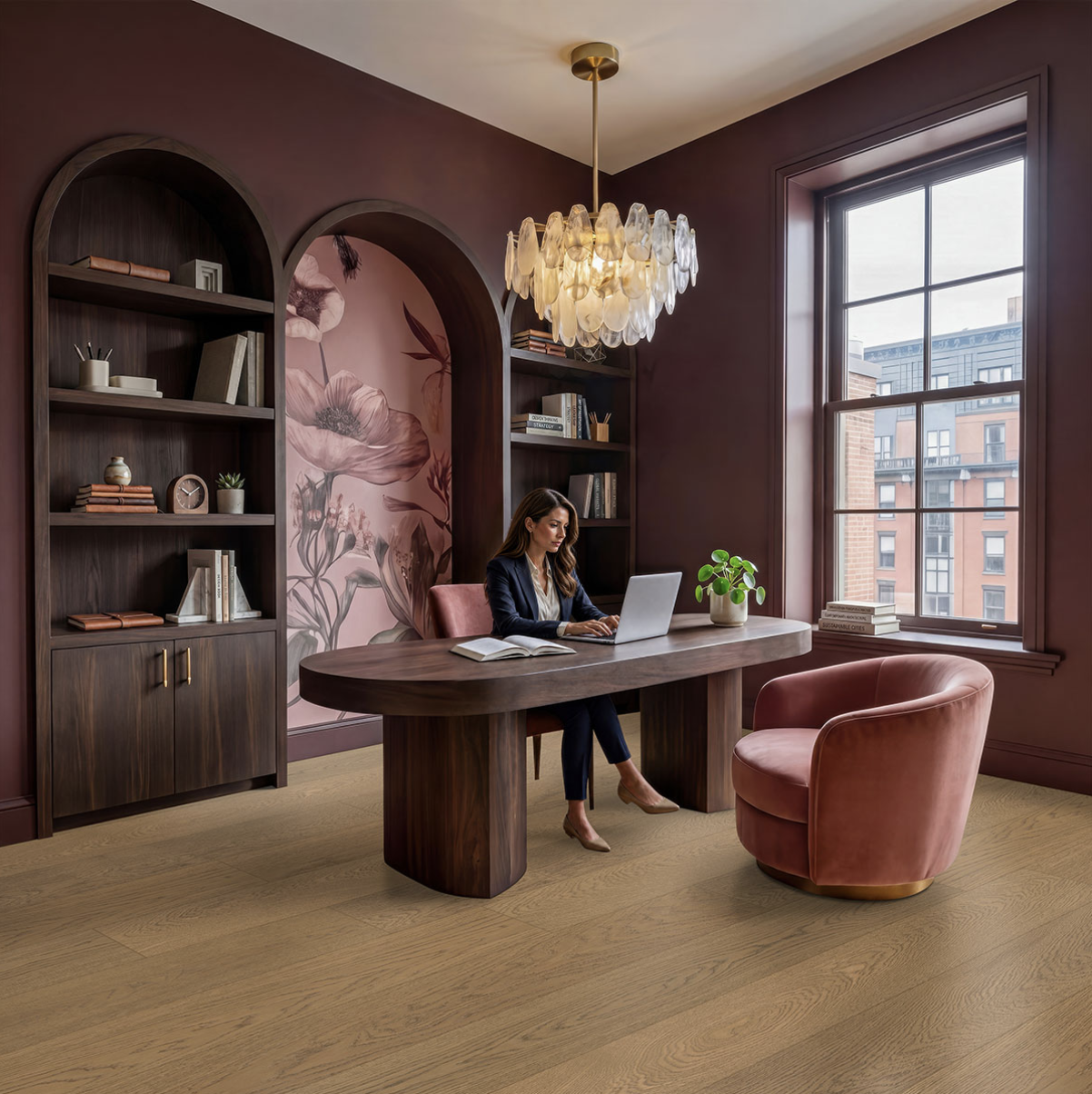 Modern burgundy office with arched shelving, wooden desk, pink velvet chair, glass chandelier, and city views