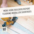 Flooring installer using pneumatic nailer on wooden floor with WE Business logo