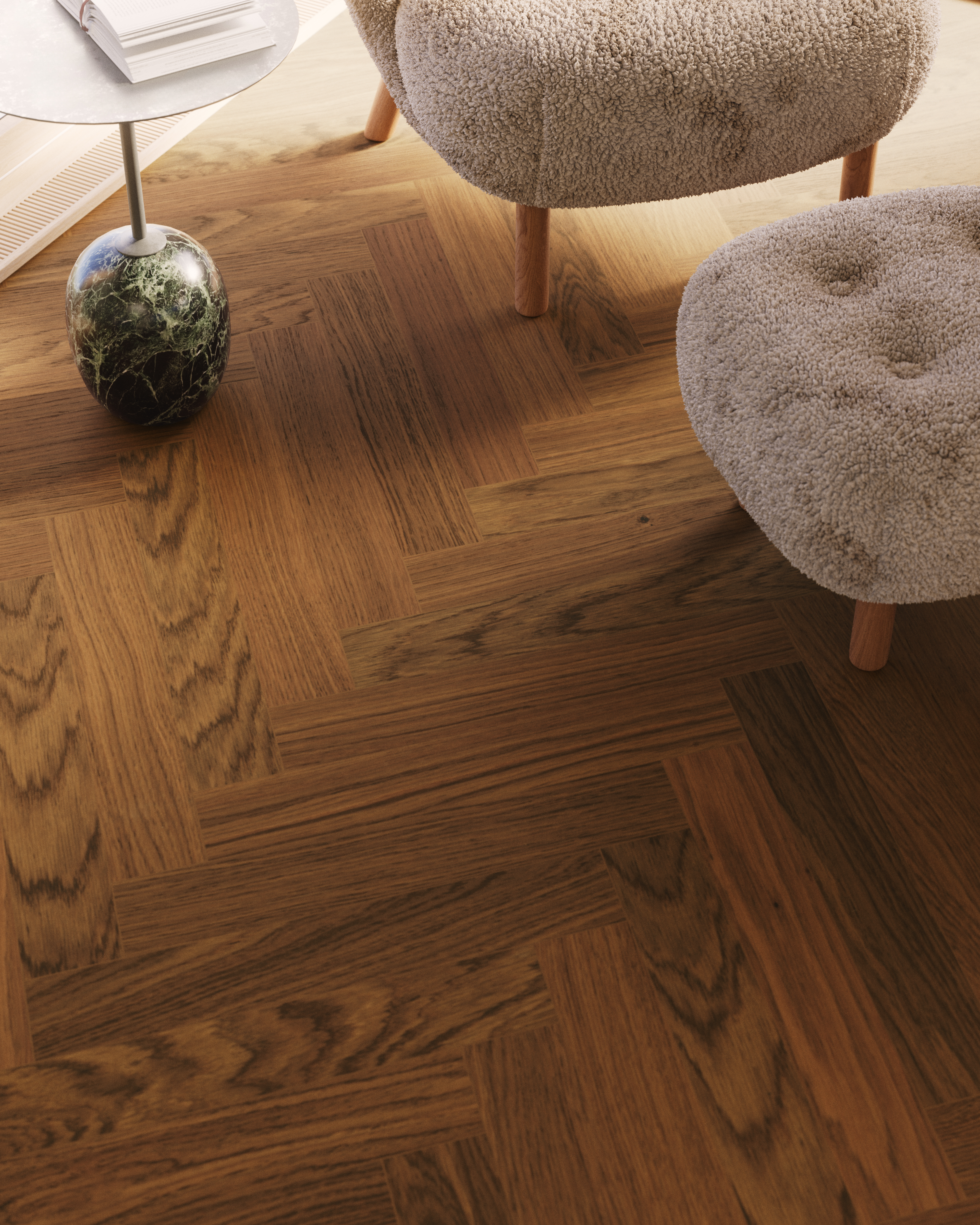 Modern living room with beige upholstered chairs, herringbone wood flooring, and potted plant with metal side table