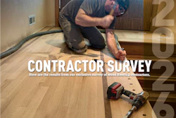 Wood flooring contractor kneeling while installing hardwood flooring with power tools on a residential floor