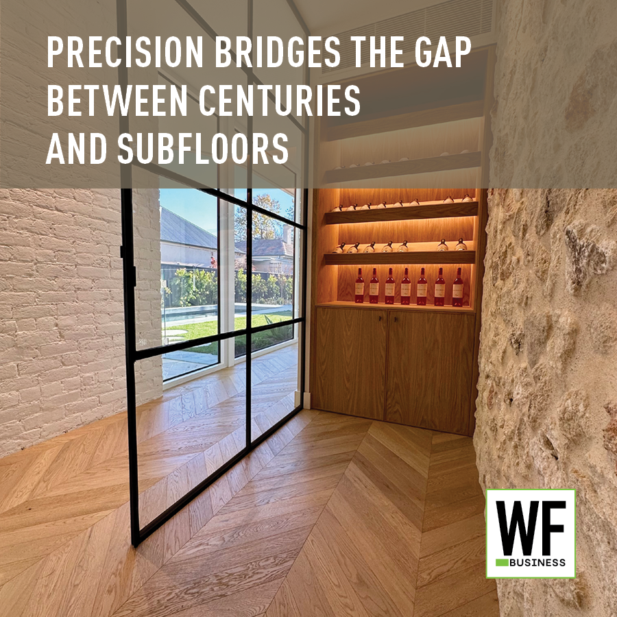 Modern interior hallway with glass doors, wooden chevron flooring, stone walls, and illuminated wine display cabinet