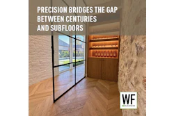 Modern interior hallway with glass doors, wooden chevron flooring, stone walls, and illuminated wine display cabinet