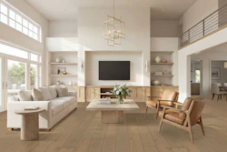 Modern open-concept living room with neutral furnishings, wood flooring, wall-mounted TV, and abundant natural light from large windows