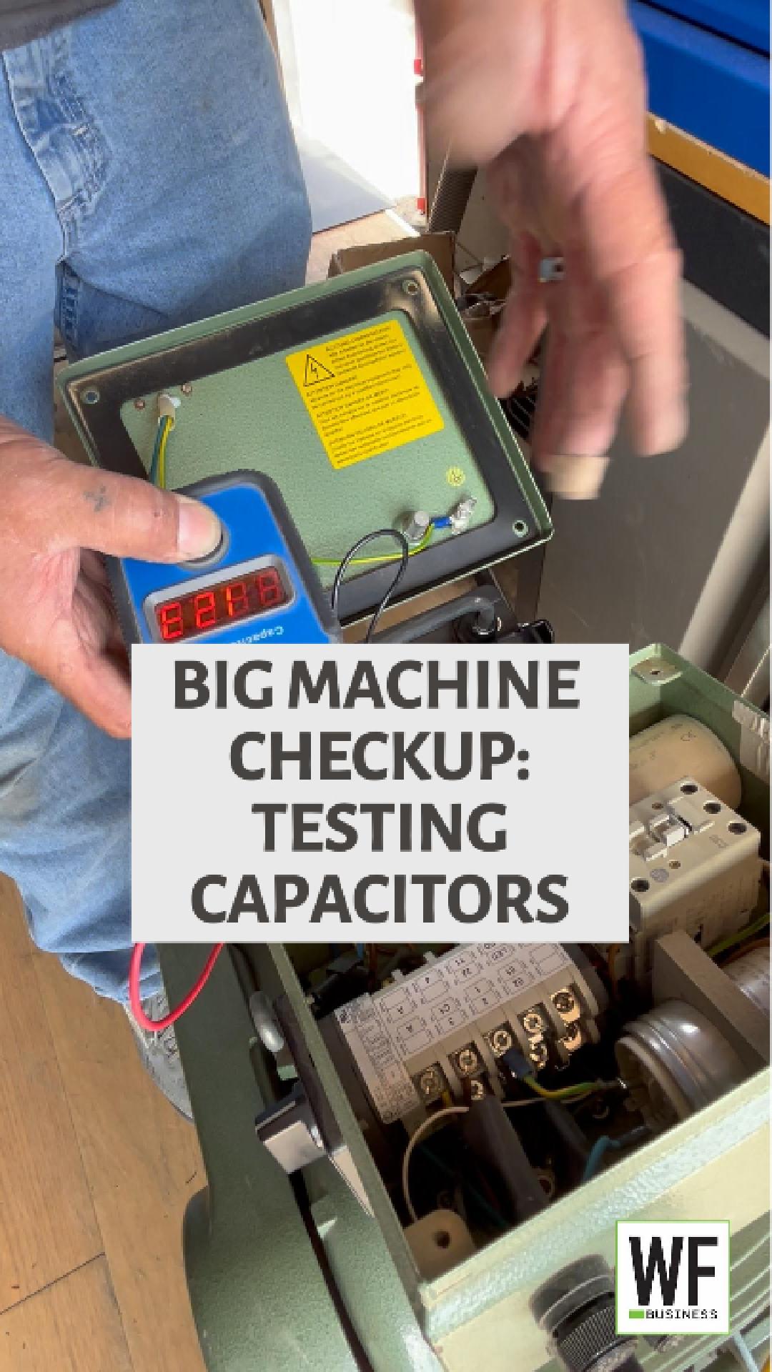 Technician testing capacitors inside industrial machine control panel during maintenance checkup