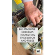 Technician inspecting electrical switches and fuses inside industrial machinery during maintenance checkup