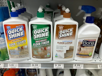 Floor cleaning products on retail shelf including Quick Shine and Bona brands with price tags